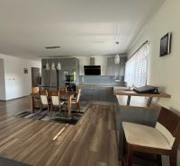 Küche in einem Einfamilienhaus mit Holzboden und Esstisch.