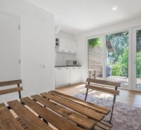 Helles Zimmer mit Holzmöbeln und Küche, Freizeitgrundstücke.