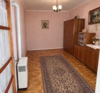 Innenraum eines Einfamilienhauses mit Holzdekorboden, Teppich und Schränken.