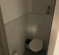 Toilette mit Fliesen und Lufterfrischer in einer 2-Zimmer-Wohnung.