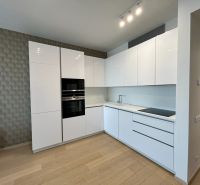 Küche in einer 2-Zimmer-Wohnung mit Holzboden und eingebauten Geräten.