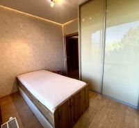 Schlafzimmer in einer 3-Zimmer-Wohnung mit Bett, Einbauschrank und dekorativer Wand.