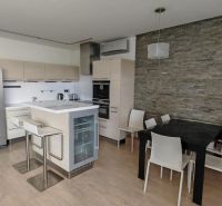 Küche in einer 3-Zimmer-Wohnung mit Holzboden und Esstisch.