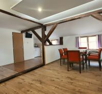 Esszimmer mit Holzbalken und Boden in Holzoptik im Ferienapartment.