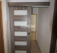 Schiebetüren in einer 3-Zimmer-Wohnung mit Holzboden und Fliesen.