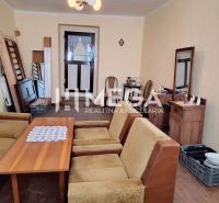 Wohnzimmer in einem Einfamilienhaus mit antiken Möbeln und Sitzgarnitur.