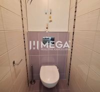 Toilette in einer 3-Zimmer-Wohnung mit hellen Keramikfliesen und einem Wandschrank.