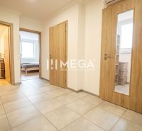 Flur in einer 3-Zimmer-Wohnung mit Keramikfliesen und Türen mit Holzdekor.