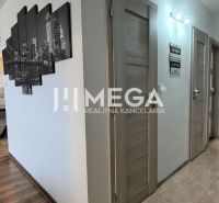 Innenraum einer 3-Zimmer-Wohnung mit einer Wand aus Steinverkleidung und einem Boden in Holzoptik.