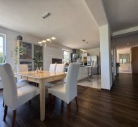 Innenraum eines Einfamilienhauses mit Esszimmer, Küche und Holzboden.