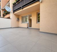 Die Terrasse der 3-Zimmer-Wohnung in der Vajanského-Straße in Trnava mit Fliesen und Grünpflanzen auf dem Balkon.