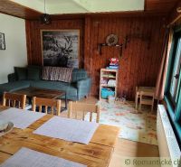 Holzinterieur der Hütte mit Sofa, Tisch und Spielzeug auf dem Boden mit Holzdekor.