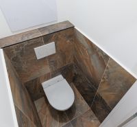 Toilette gefliest mit Keramikfliesen in einer 2-Zimmer-Wohnung.