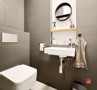 Kompaktes Badezimmer in einer 2-Zimmer-Wohnung mit Waschbecken, Spiegel und Toilette.