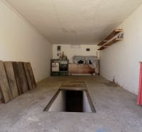 Garagen mit Montagegrube und Lagerräumen mit Regalen und Holzflächen.