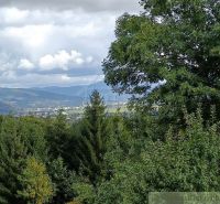 Blick auf die Natur von der Hütte in Staškov mit Wäldern und Hügeln im Hintergrund.