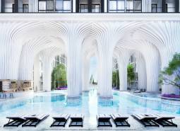 Luxuriöse Wohnbebauung mit Pool und weißen Säulen, die an futuristische Architektur erinnert.