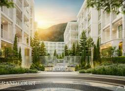 Wohnungsbau in Phuket mit eleganter Architektur und gepflegter Grünanlage im Außenbereich.