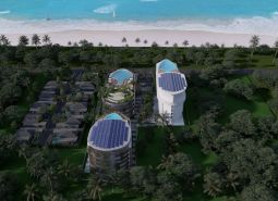 Wohnungsbau am Strand in Phuket mit modernen Gebäuden und Pools, umgeben von Palmen.