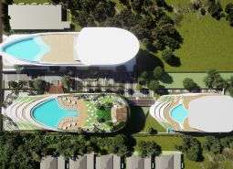 Luftaufnahme des Wohnungsbaus in Phuket mit Dachpools und Grünflächen.