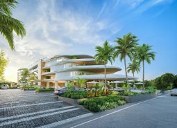 Wohnungsbau in Phuket mit moderner Architektur, umgeben von Palmen und Parkplätzen.