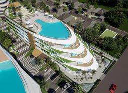 Wohnungsbau in Phuket mit Pools auf dem Dach und tropischem Grün.