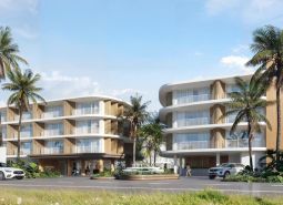 Wohnungsbau in Surat Thani mit Palmen und moderner Architektur.