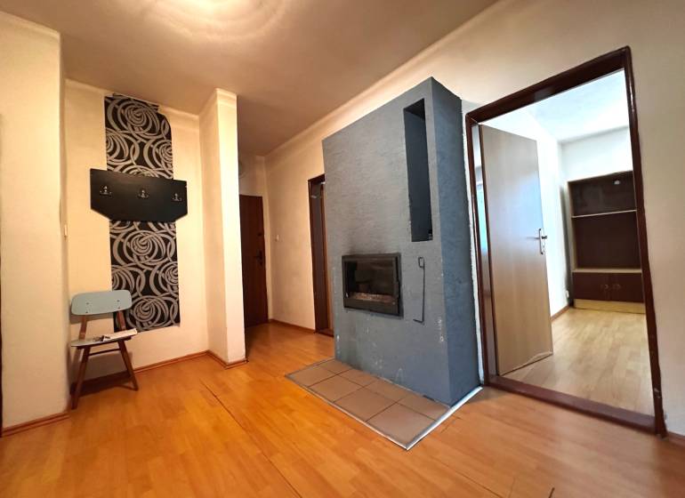 Der Flur in einer 3-Zimmer-Wohnung mit Holzboden und Wandhaken.