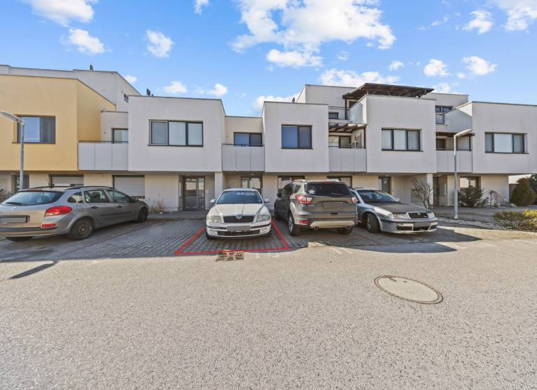 Auf der Mondstraße sieht man einen Parkplatz vor Reihenhäusern und eine Außenwohnung mit 2 Zimmern.