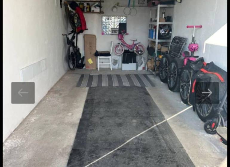 Die Garage enthält Fahrräder, Kinderwagen und Regale mit Stauraum.