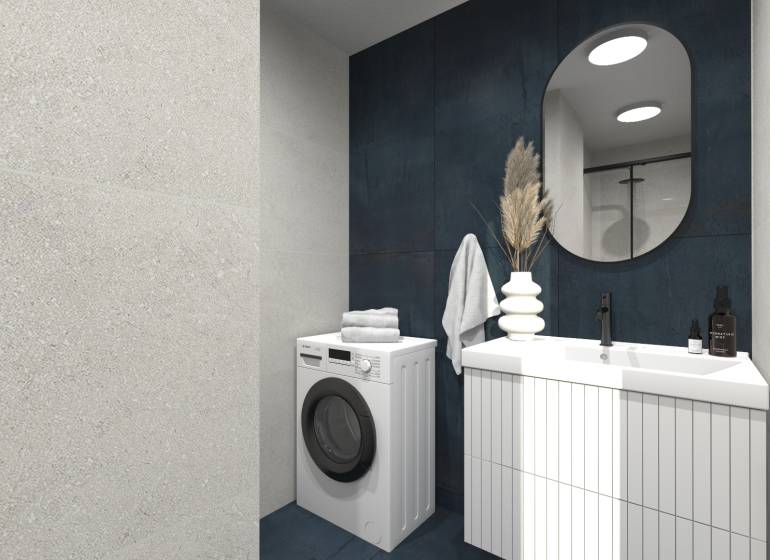 Badezimmer in einer 2-Zimmer-Wohnung mit Waschmaschine, Waschbecken, Spiegel und dekorativen Elementen.