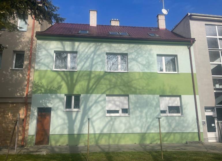 Einfamilienhaus in der Kalinčiakova-Straße in Piešťany, grüne Fassade, Schatten eines Baumes.