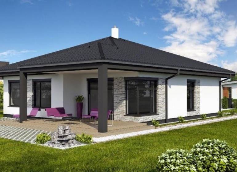 Ein Einfamilienhaus in Most pri Bratislave mit Terrasse, Rasen und Sitzgelegenheit im Freien.