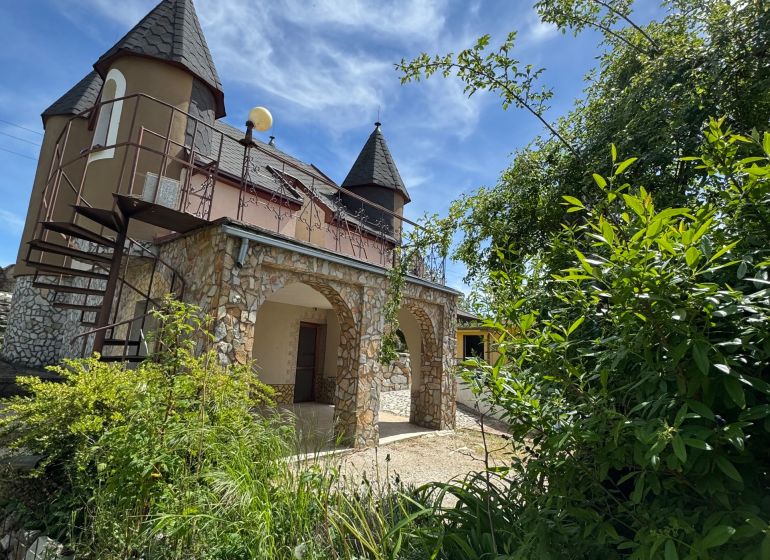 Das Haus in der Agátová-Straße in Šahy mit Steinbögen und Türmchen.