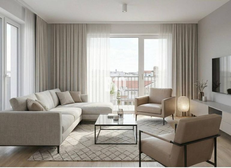 Wohnzimmer mit Sofa, Sesseln und Holzboden in einer Zweizimmerwohnung.