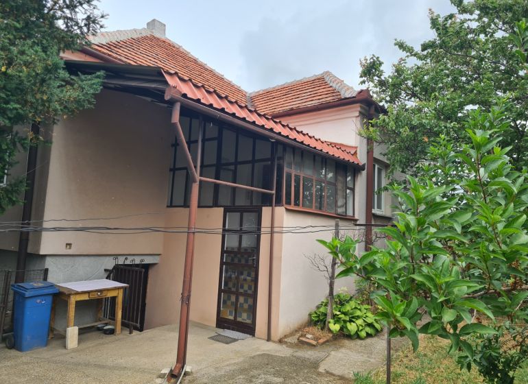 Ein Einfamilienhaus in Dulovce mit Terrasse, Garten und traditionellem Schrägdach.