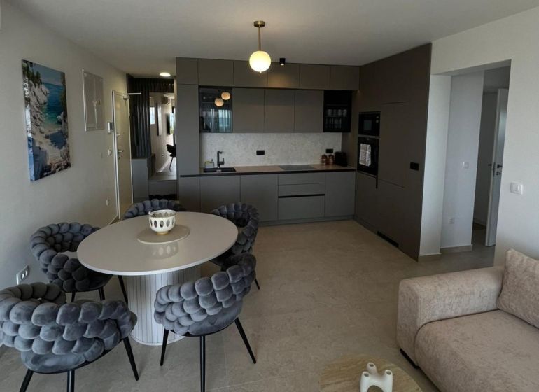 Stilvolle Küche und Esszimmer in einer 3-Zimmer-Wohnung mit einem großen runden Tisch.