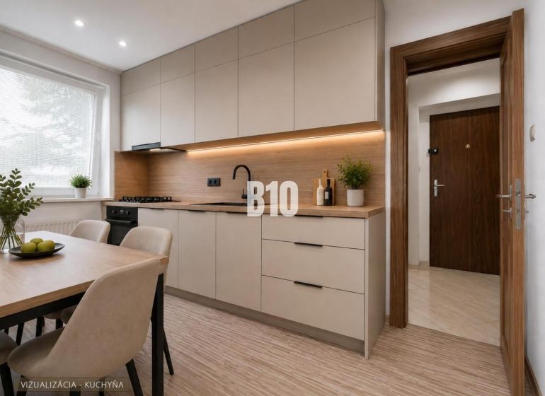 Helle Küche mit Holzboden und einfachem Tisch in einer 3-Zimmer-Wohnung.