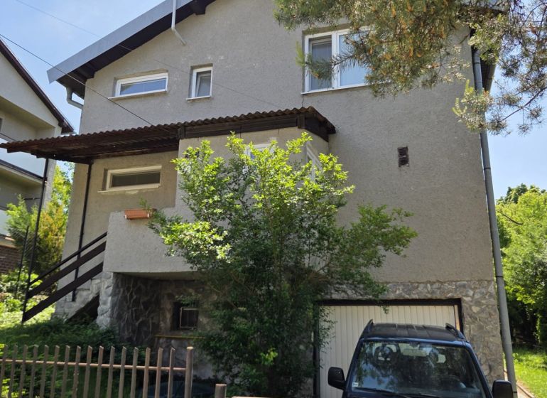 Einfamilienhaus in Nižná Hutka mit Garten und Garage, umgeben von Grün.