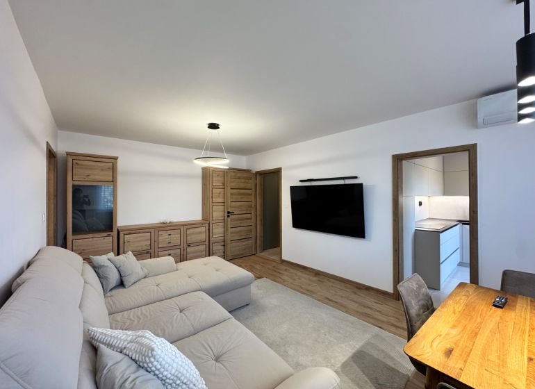 Wohnzimmer in einer 3-Zimmer-Wohnung mit Holzboden und modernen Möbeln.