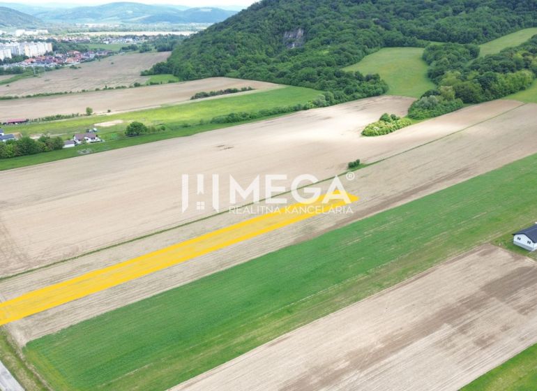 Hügelige Landschaft bei Jasenov mit Wohnbaugrundstücken, umgeben von Feldern und Wäldern.