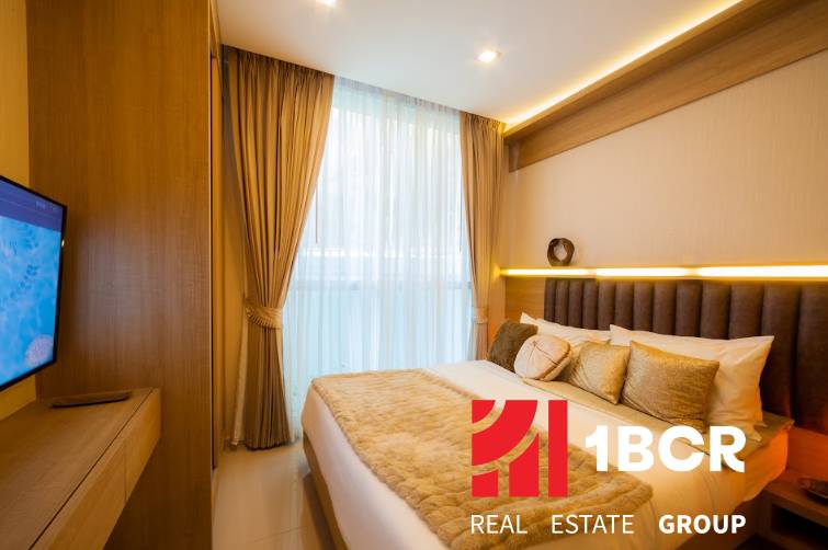 Schlafzimmer mit Bett und Fernseher in einer 3-Zimmer-Wohnung, Interieur in neutralen Farben.
