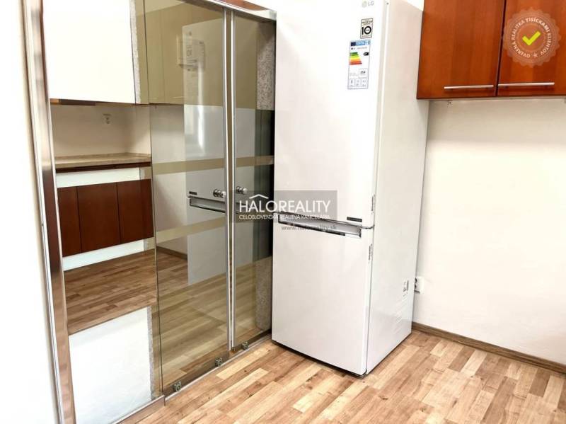 Küche mit Einbauschrank und Kühlschrank in einer 3-Zimmer-Wohnung.