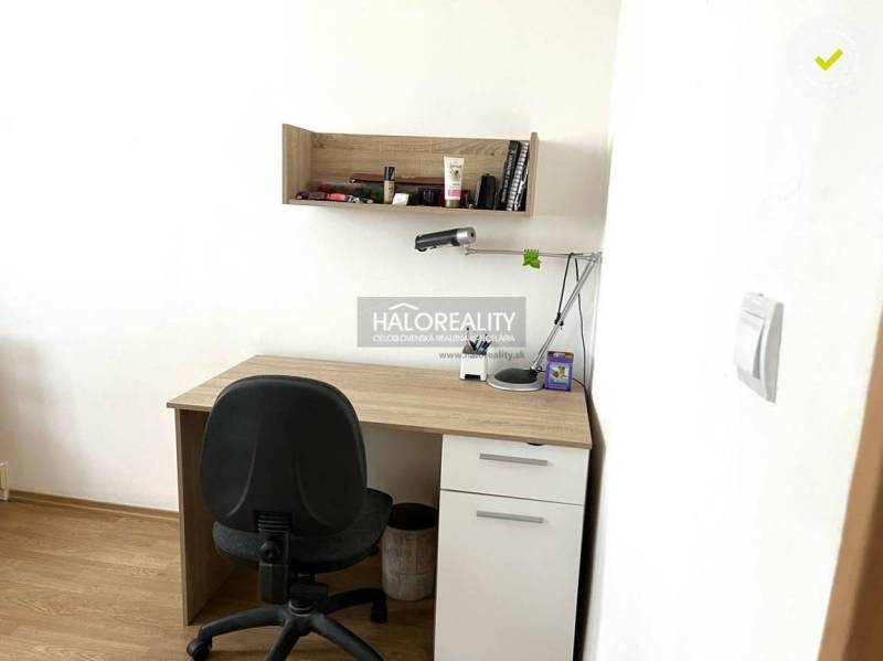 Schreibtisch mit Regal und Bürostuhl in einer 3-Zimmer-Wohnung.