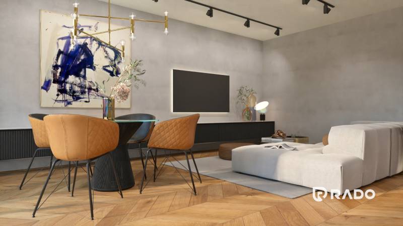 Wohnzimmer in einer Zweizimmerwohnung mit einem bequemen Sessel und künstlerischer Dekoration.