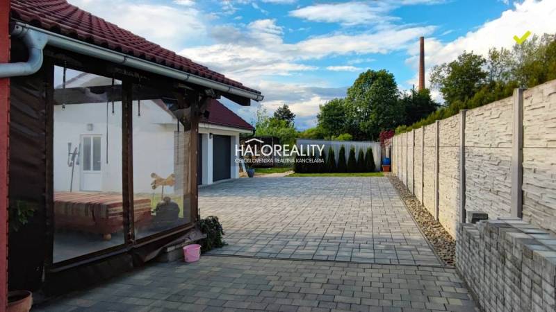 Einfamilienhaus in Kalinovo mit gepflastertem Hof, Terrasse und Umzäunung.