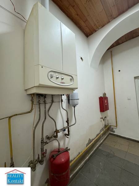Kessel und Rohrleitung in Geschäftsräumen, Wand mit leichten Abnutzungsspuren.