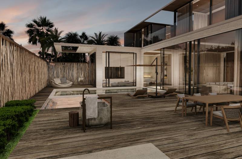Ein Einfamilienhaus mit einer geräumigen Terrasse und einem Pool, umgeben von tropischen Pflanzen.