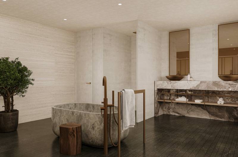 Das Badezimmer eines Einfamilienhauses mit einer ovalen Steinvanna und eleganten Waschbecken.