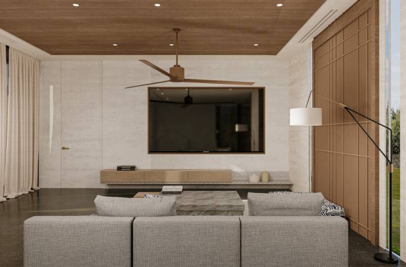 Wohnzimmer in einem Einfamilienhaus mit einem bequemen Sofa und einem Fernseher an der Wand.